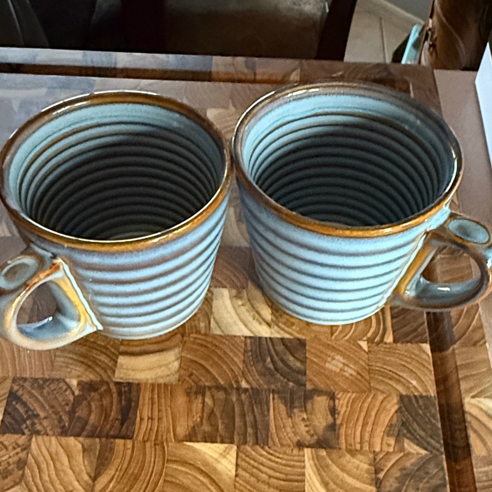 Two Starbucks coffee mugs